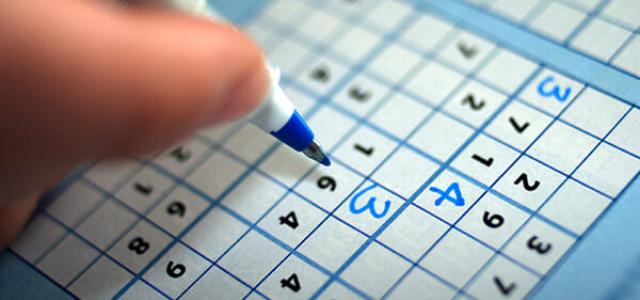 person playing sudoku