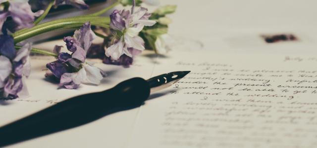 purple flowers on paper by Debby Hudson courtesy of Unsplash.