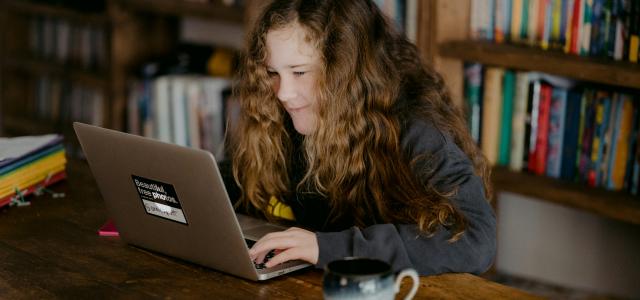 woman in black jacket using macbook pro by Annie Spratt courtesy of Unsplash.