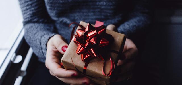 person holding present box by freestocks courtesy of Unsplash.